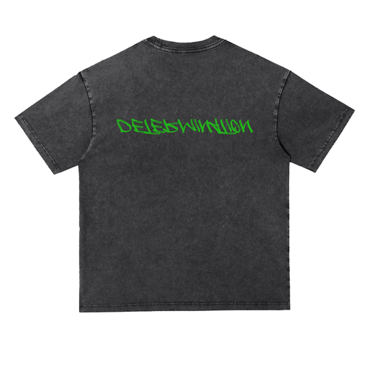 A dark gray acid-wash t-shirt shown from the back, featuring the word 'Determination' printed in a bright green graffiti-style font across the upper back.